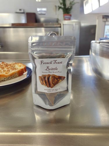 French Toast Brittle bag on stainless steel counter with french toast on a plate