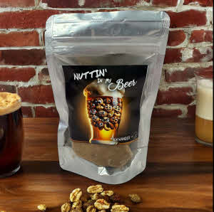 Nuttin In My Beer Brittle Bag on counter with nuts and beer glass